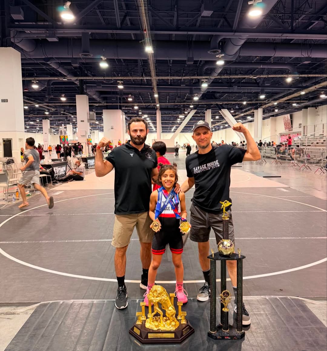 Coach Max and Coach Viviano with a Savage House champion and team trophies