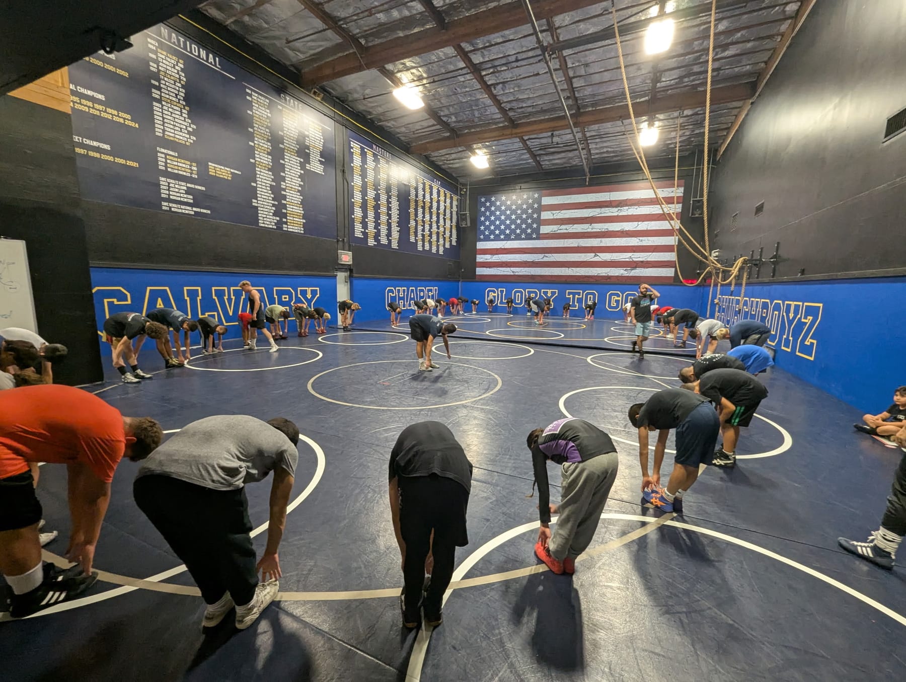 Savage OC wrestlers warming up in the Calvary Chapel mat room